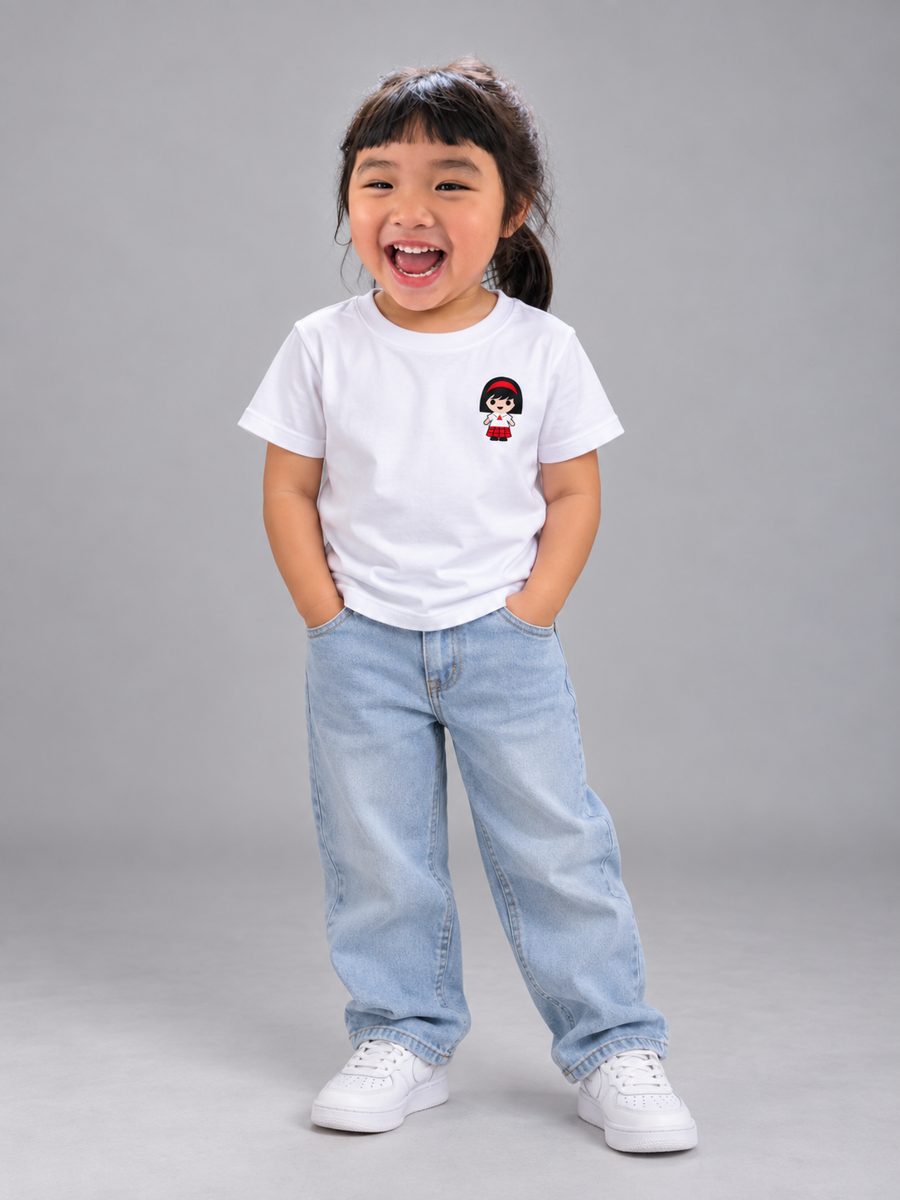 Girl wearing the kids' Velada shirt with light jeans
